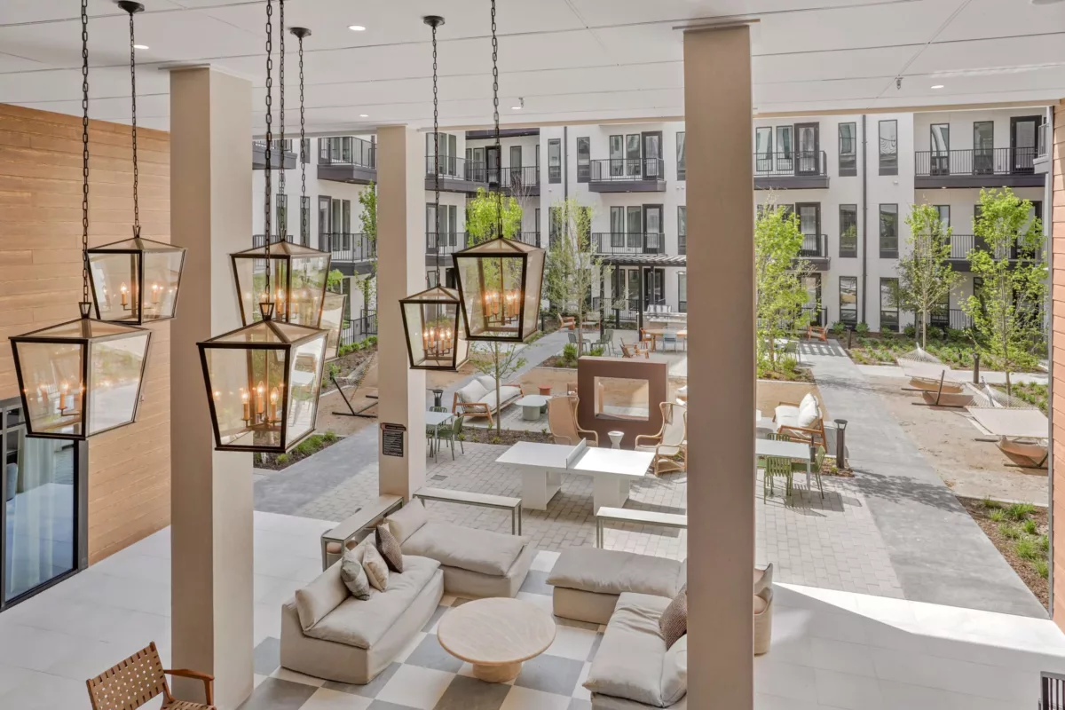 Courtyard view with hanging lantern lights and lounge seating below.